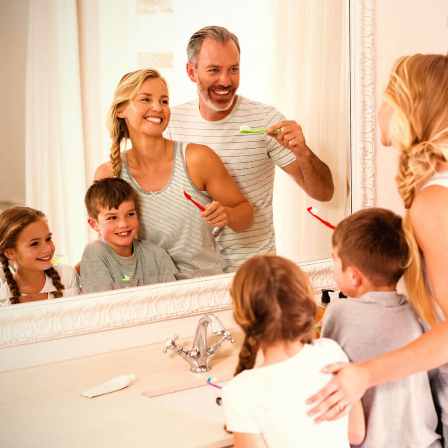 Family brushing their teeth